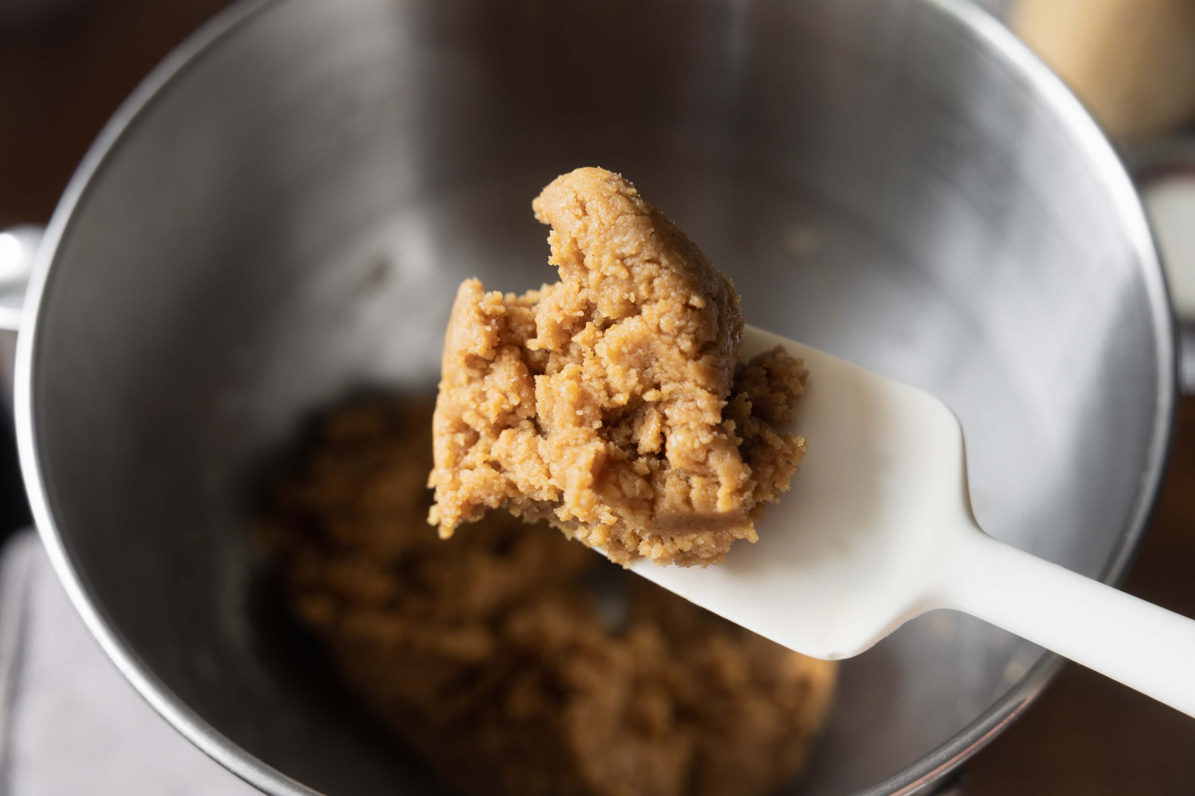 Raw peanut butter cookie dough resting in mixing bowl.